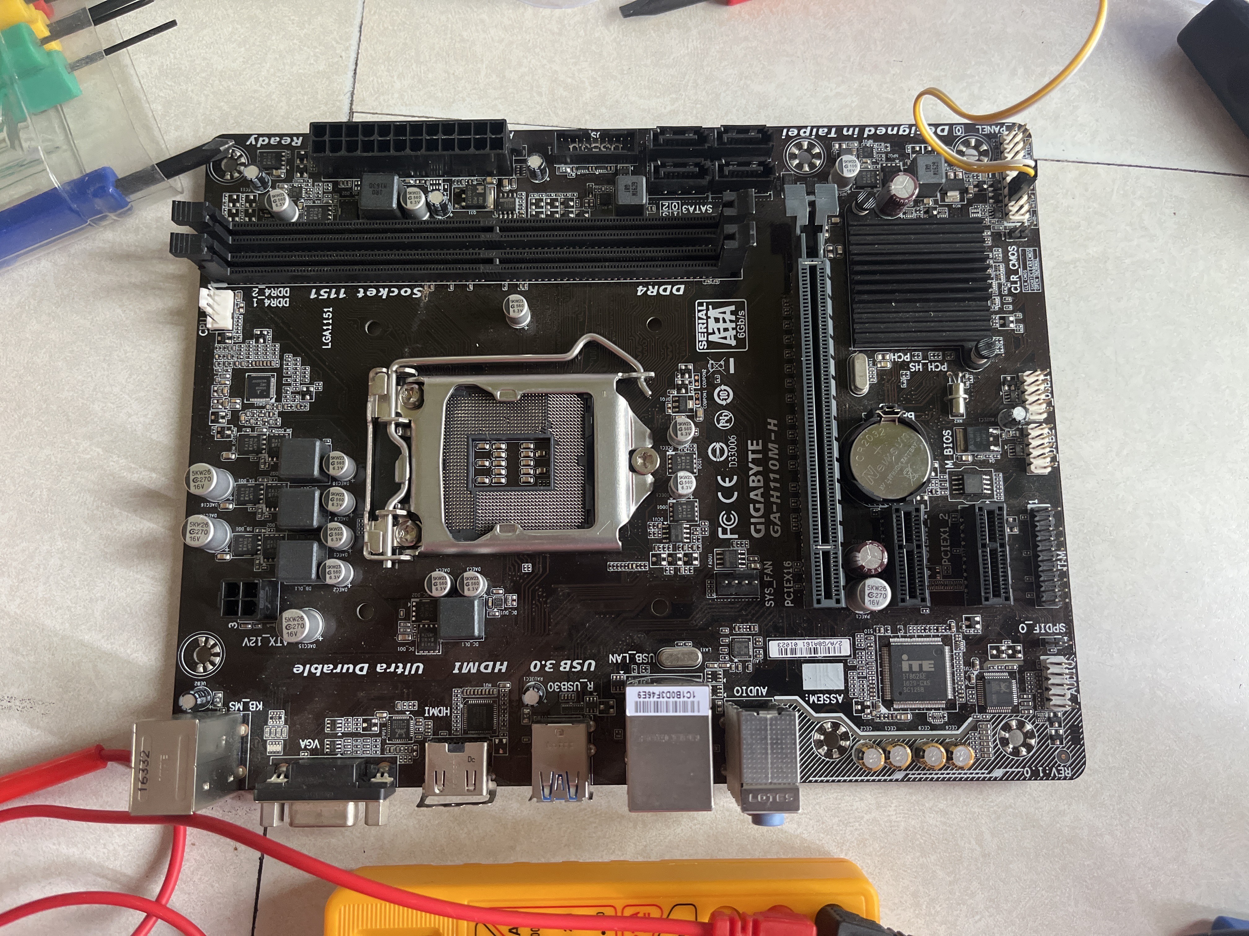 The Gigabyte H110M-H motherboard with its CPU socket exposed