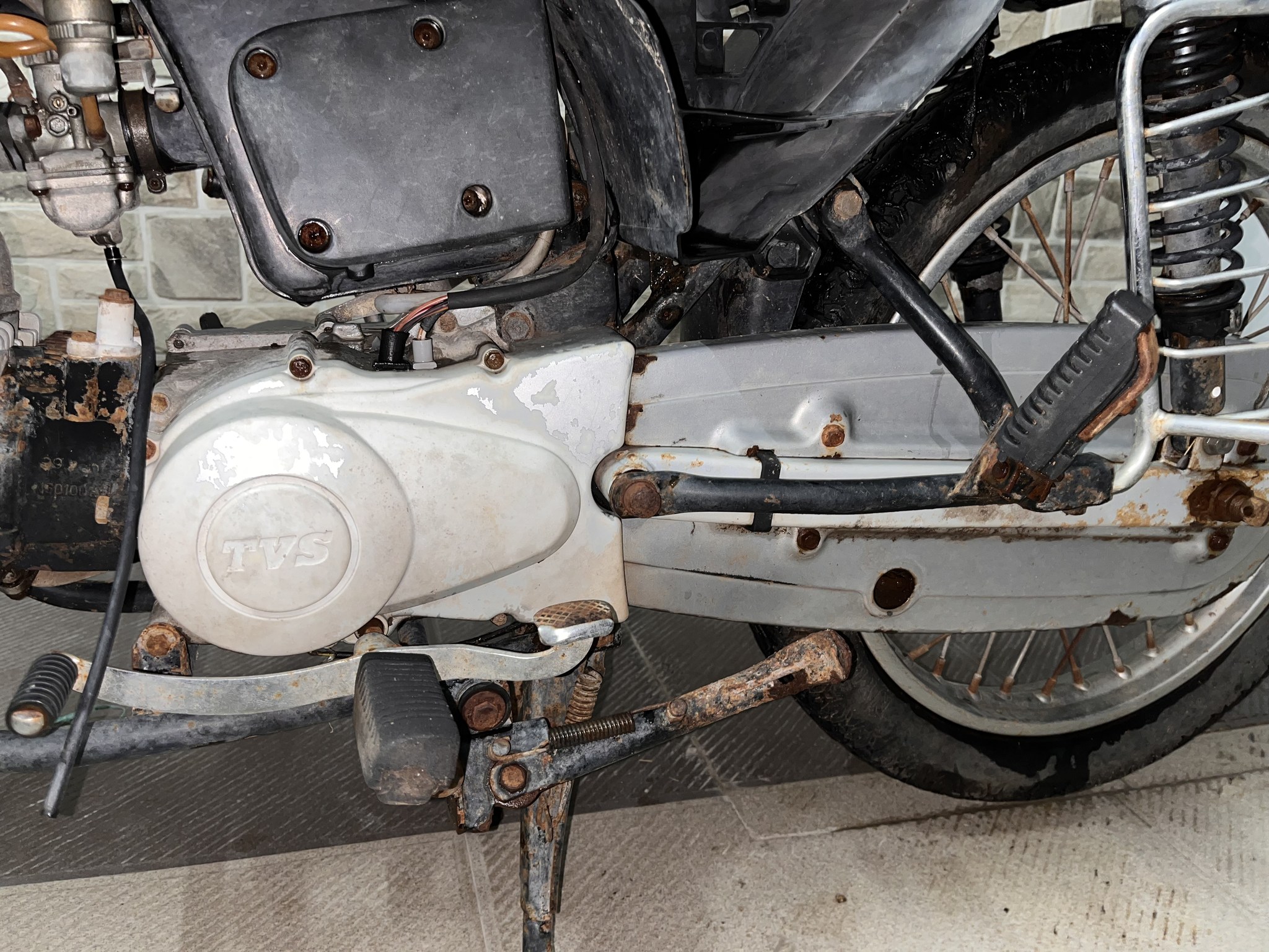 Rusty left-side drivetrain, panels removed