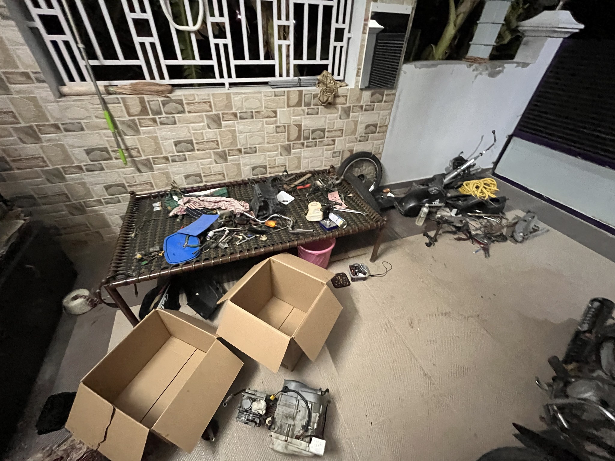 Dismantled bike parts spread out at night