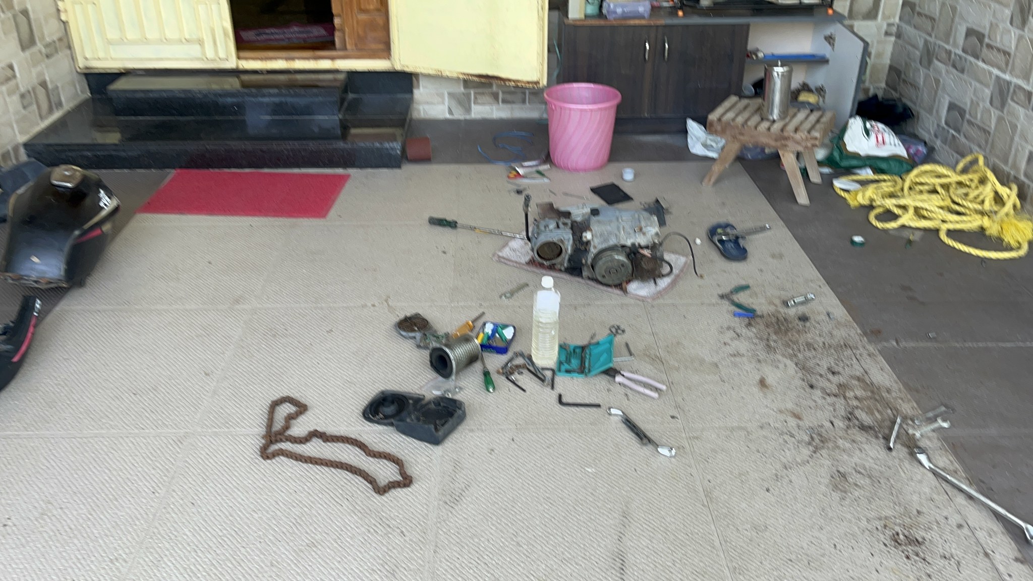 Dismantled parts and tools spread on floor