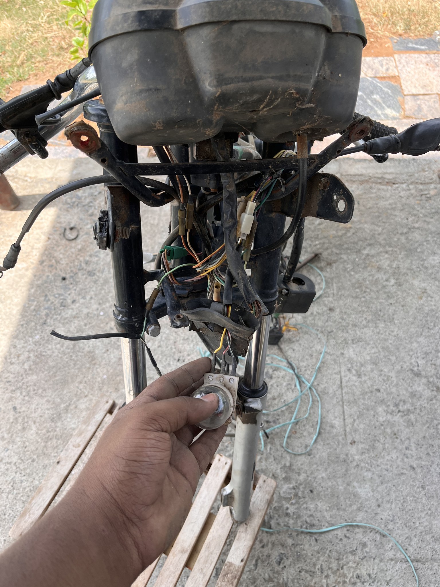 Exposed front wiring with hand holding bulb holder