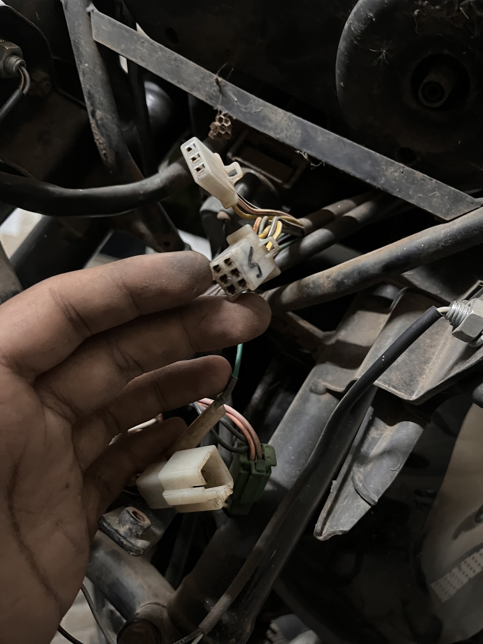 Hand holding wiring connectors during rewiring