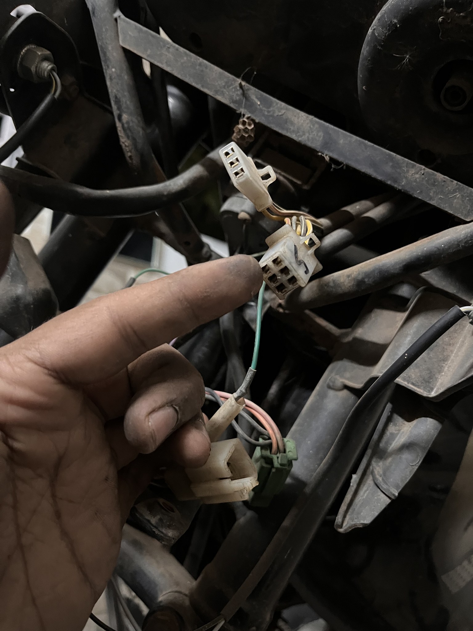 Wiring connectors held up close during rewiring