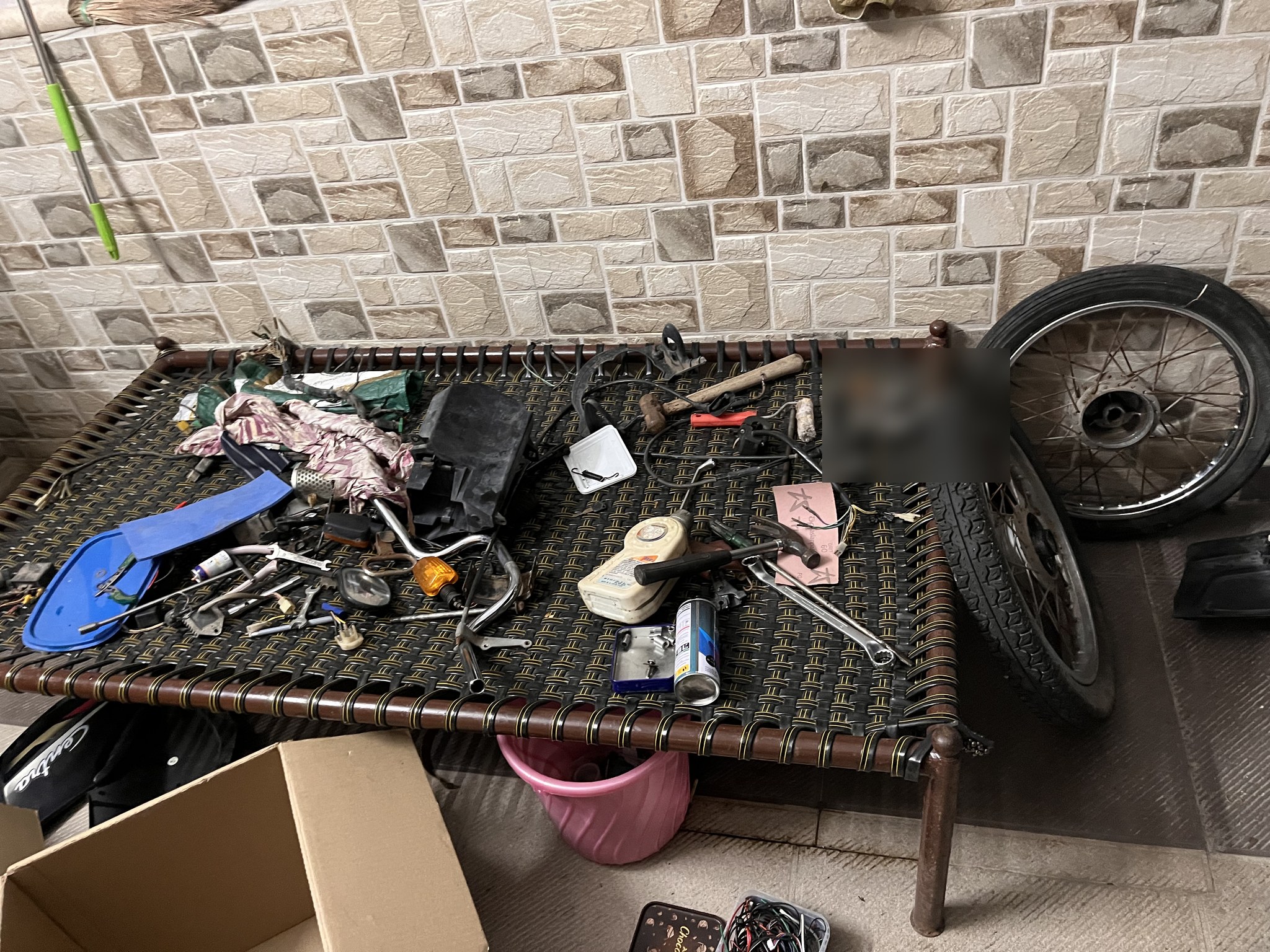 Dismantled parts laid out on cot